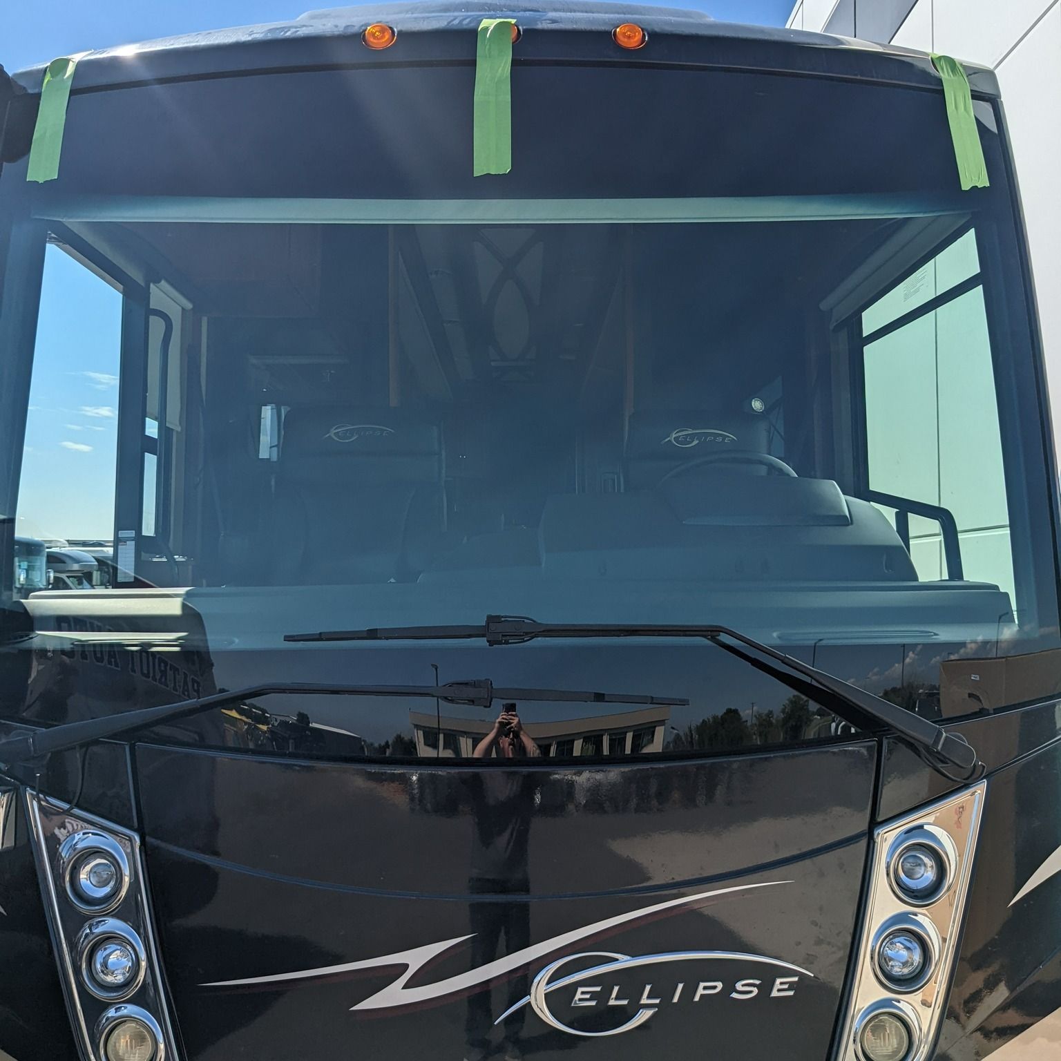 Newly installed RV windshield on a black Ellipse motorhome by Patriot Auto Glass